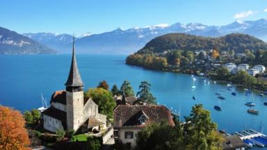 The castle church thrones against the beautiful backdrop of Lake Thun
